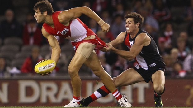 Last time... Sydney's Josh Kennedy is tackled by St Kilda's Lenny Hayes.