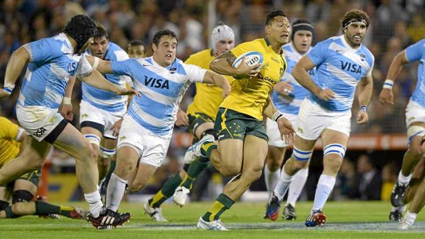 Catch me if you can: Wallabies hat-trick hero Israel Folau leads the Pumas on a merry dance in Rosario.