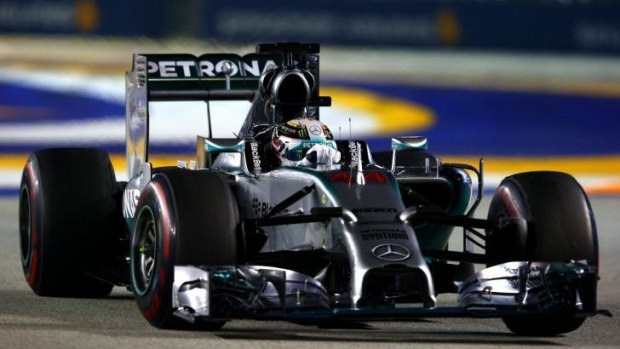 Night rider: Lewis Hamilton on his way to victory in Singapore and the formula one championship lead.