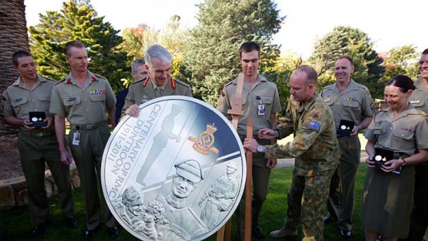 Lieutenant General Ken Gillespie unveils the Royal  Military College of Australia Centenary Coin at Duntroon House Gardens in Canberra