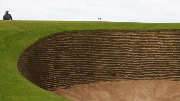 Taming the beast &#8230; Tiger Woods and one of Lytham's 206 treacherous bunkers.