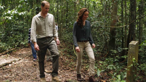 Getting away from it all ... Prince William and Kate, the Duke and Duchess of Cambridge, walk through a rainforest in Malaysia.