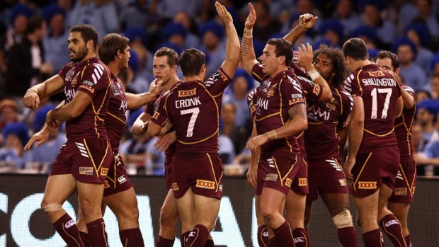 The Maroons celebrate a try during game one of the ARL State of Origin series between the Queensland Maroons and the New South Wales Blues at Etihad Stadium on May 23, 2012 in Melbourne, Australia.