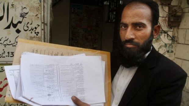 Mustafa Kharal, lawyer of  pregnant woman Farzana Parveen who was stoned to death, shows her marriage certificate in Lahore, Pakistan.
