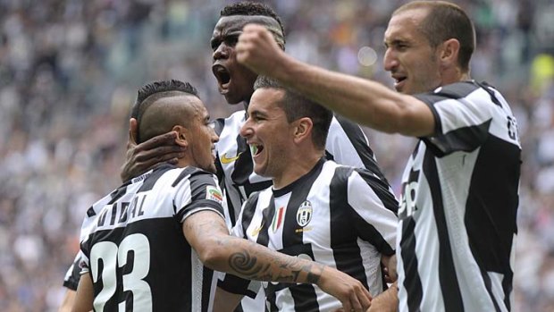 Arturo Vidal (left) celebrates Juventus' win.