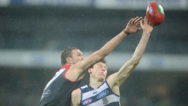 Rain pours down as the Demons' Max Gawn and Geelong's Mark Blicavs contest the ruck.