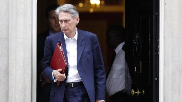 Britain's Foreign Secretary Philip Hammond leaves 10 Downing Street following a meeting of the emergency response committee.