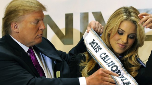 Still Miss California ... Donald Trump places a ribbon on Carrie Prejean.