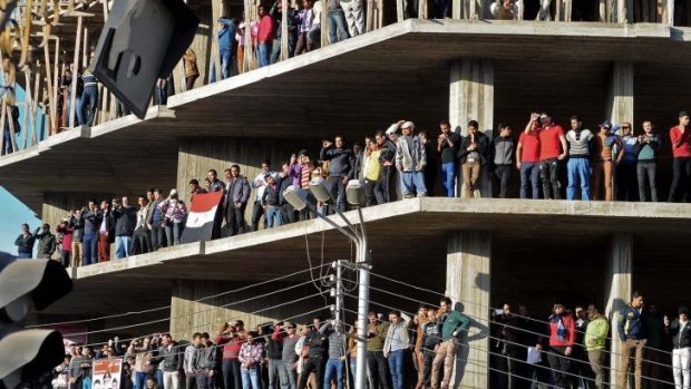 Egyptians attend the funeral of a dozen policeman and a civilian killed from an explosion at a police headquarters, in the Nile Delta city of Mansoura, 110 kilometers north of Cairo, Egypt.
