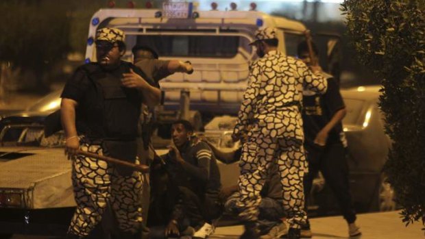 Members of Saudi security forces detain Ethiopian workers during a riot in Manfouha, southern Riyadh.