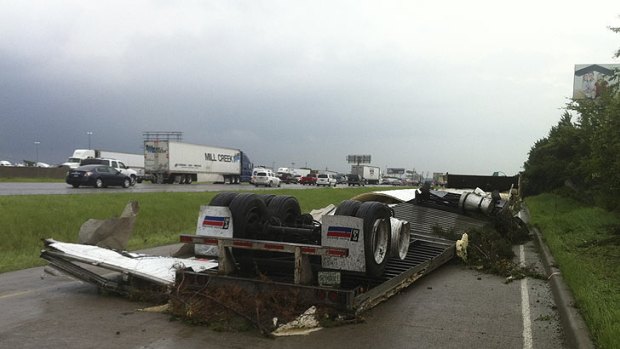 A semi-trailer is left upturned on a Texas road after a series of tornadoes hit.