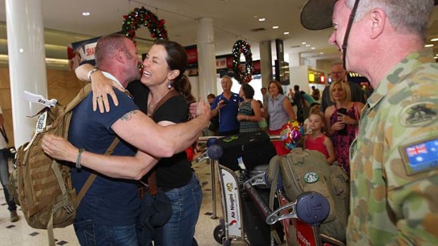 Home for Christmas: Sally Beaumont greets Jon Lane at Sydney Airport.