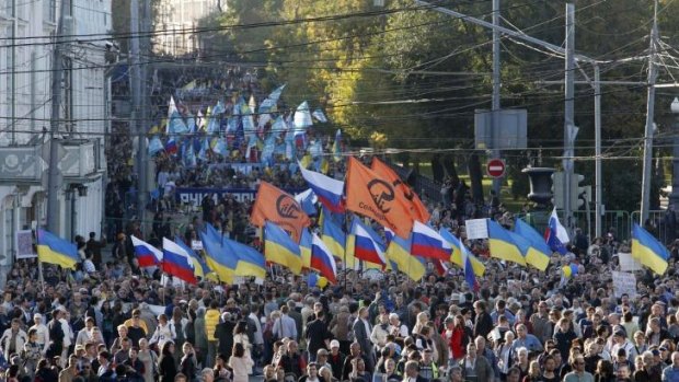 Tens of thousands of Russians marched through Moscow in protest at the Ukraine conflict.