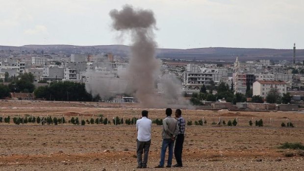 Smoke rises from a residential area near Kurdish border town of Kobani during an attack from Islamic State fighters.