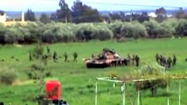 Armoured vehicles... still from amateur video posted on a social media website said to show an advance on Daraa.