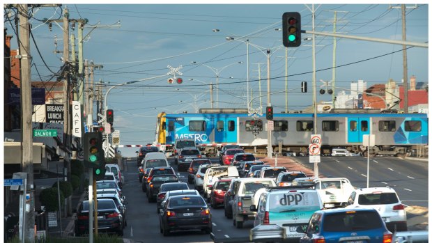 Traffic queues as a train crosses North Road in 2015, before the level crossing was removed.