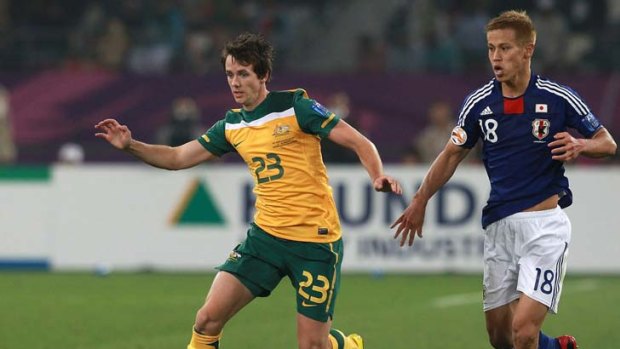 Robbie Kruse gets away from Japan's Keisuke Honda in last year's Asian Cup. The Socceroos hope to do the same tomorrow.