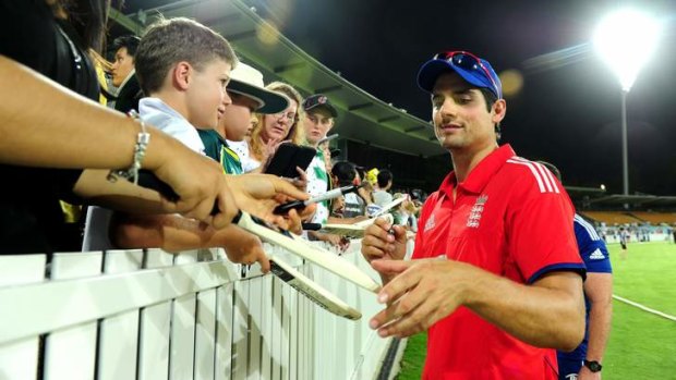 England Captain Alistair Cook signs autographs after the PM's XI game. Despite the win, Cook still failed with the bat.