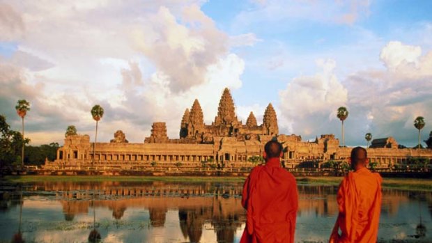 Worship &#8230; Buddhist monks look across at Angkor Wat.