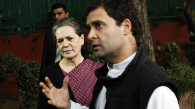 Chief of India's ruling Congress party Sonia Gandhi (left) watches as her son, lawmaker Rahul Gandhi speaks during a news conference in New Delhi.