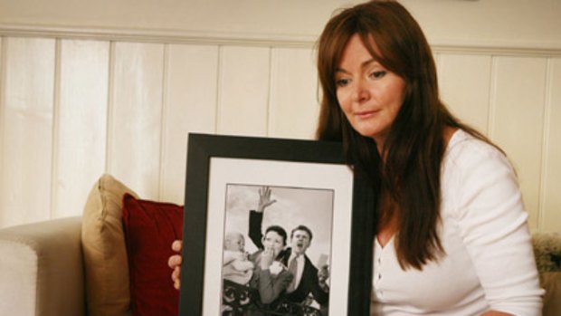 Sorrow ... Marisa Robbins holds a framed photograph of her parents, Lloyd and Mary Martin, who died in the bushfires at their property in Humevale.