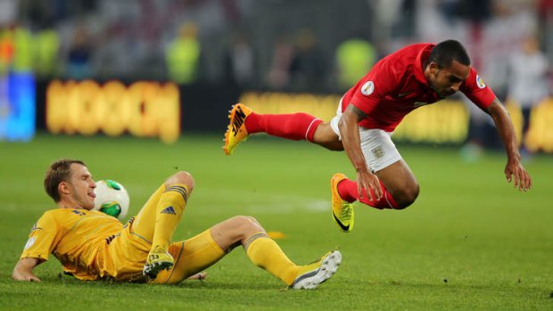 Down and out: Theo Walcott in action for England in qualifying against Ukraine but the injured Arsenal star won't feature at the World Cup.