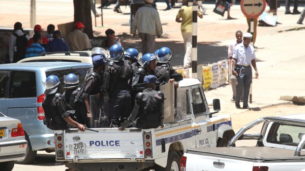 Riot police patrol the streets of Harare on Wednesday.