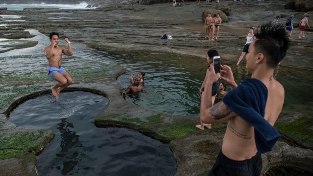 Tourists pose for photographs earlier in January at the Figure Eight Pools in the Royal National Park.