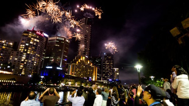 Revellers watch New Year's Eve fireworks at Southbank.
