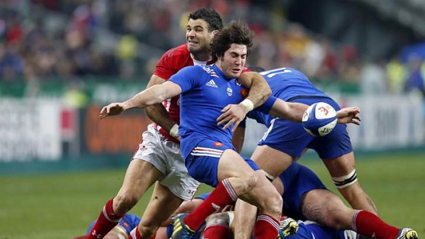 Maxime Machenaud of France (in blue) struggles with Mike Phillips of Wales during the Six Nations match at the Stade de France.