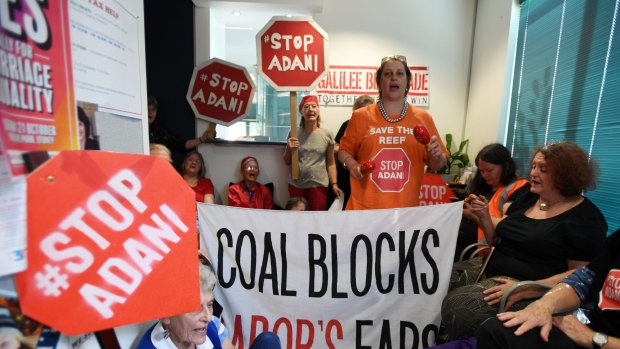 Protesters in Sydney make their views on Adani clear. The NAIF is considering a $1 billion loan to a company associated with Adani Group patriarch Gautam Adani. 