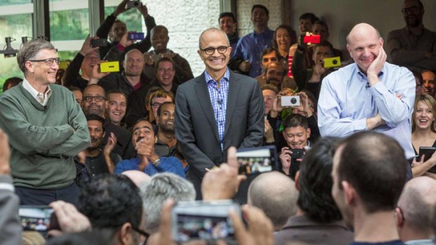 Satya Nadella (C), Microsoft's new CEO, addresses employees along with founder and technology advisor Bill Gates (L) and outgoing CEO Steve Ballmer on the company's campus in Redmond.
