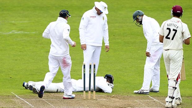 Injured ...  Mark Boucher lies on the floor after being hit by a bail.