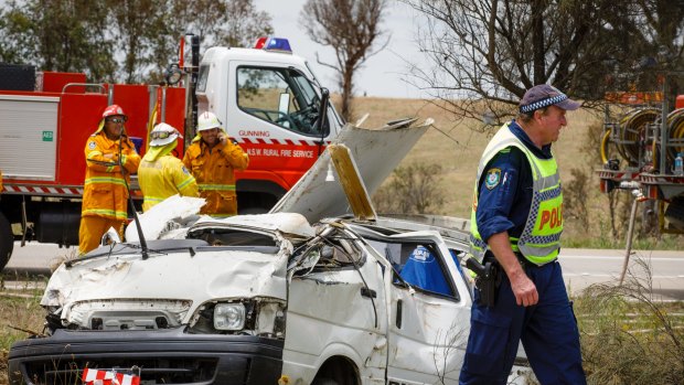 Emergency services personnel attend a crash scene on the Hume Highway near Oolong where a female driver of a van died on Thursday morning after accidentally clipping a truck.