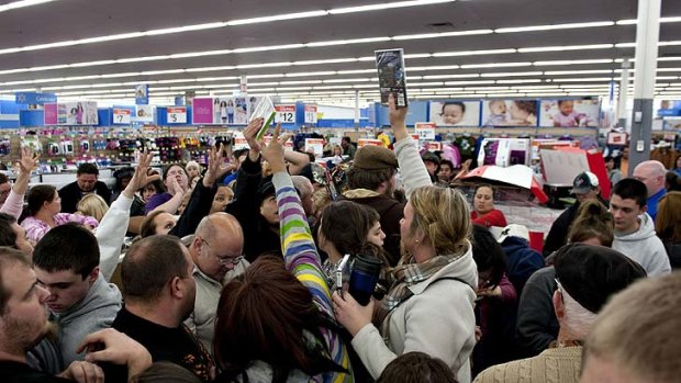 Crowds vie for cut-price video games.