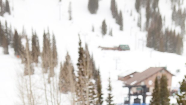 A snowboarder takes a break at a ski resort in Utah.