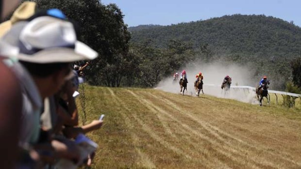 Big day out ...  crowds boot home a winner at the Buchan Race Course.