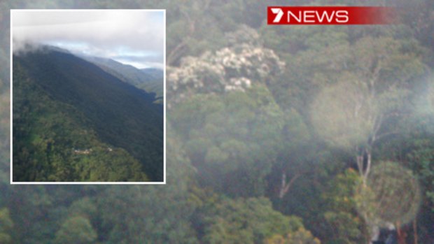 The crash site near Isurava (inset) with wreckage barely visible (bottom right) below the jungle canopy. Photos: Channel Seven