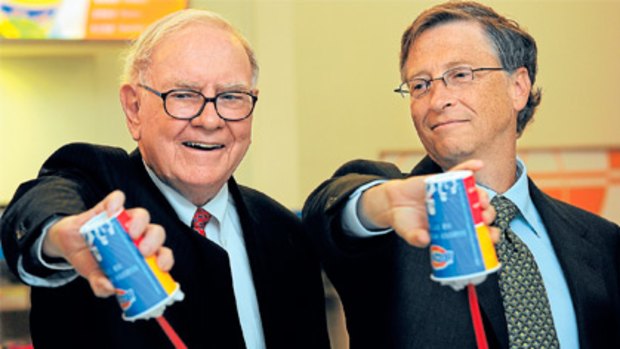 Warren Buffett (left) and Bill Gates upend Dairy Queen desserts at the opening of a new branch of the success story in China.