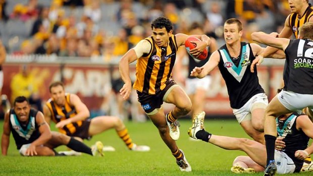 Let's put on a show: Cyril Rioli bursts free of a couple of Port Adelaide opponents yesterday.