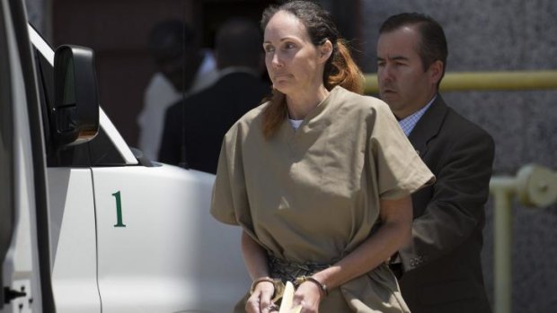 Wearing restraints, Shannon Guess Richardson is escorted out of the federal courthouse in Texarkana, Texas on Wednesday.