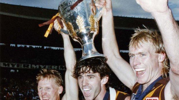Hawk heroes: Andy Collins, Dean Anderson and Peter Curran celebrate the 1989 premiership.