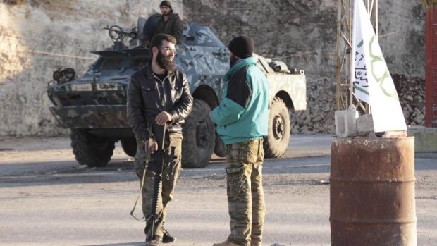 Fighting al-Qaeda: Members of the Islamic Front man a checkpoint between the villages of Kafaroumeh and Maarat al-Nuaman in Syria's Idlib province.