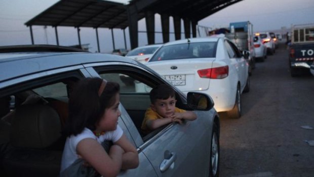 Residents of Mosul at a Peshmerga checkpoint halfway between Mosul and Erbil in semi-autonomous Iraqi Kurdistan.