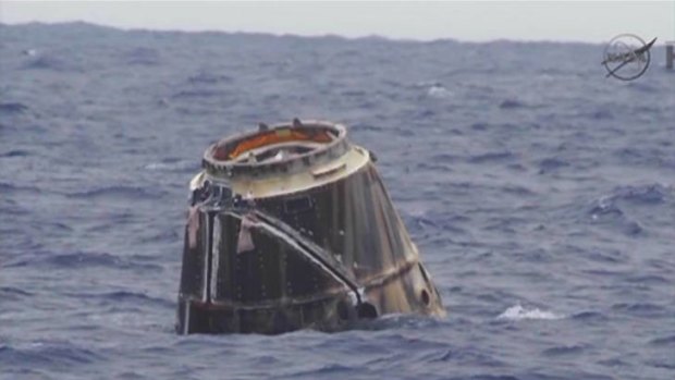 Space Exploration Technologies' unmanned Dragon capsule floats in the Pacific Ocean off of Baja California in this May 31, 2012 handout image from NASA Tv.