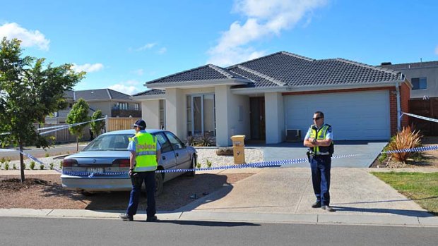 The scene ... Police watch over a house in Point Cook, where Sarah Cafferkey's body was found stuffed in a bin.