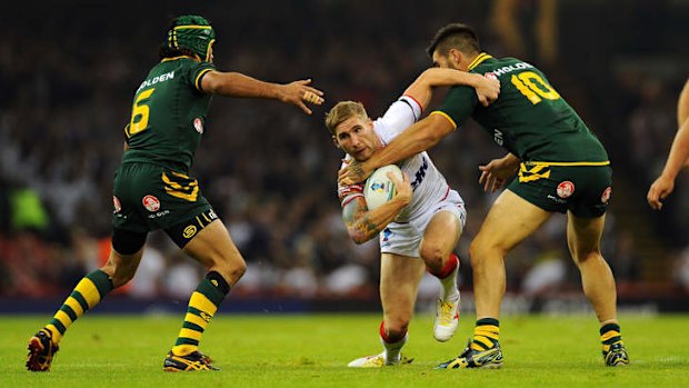 Auckland bound: England fullback Sam Tomkins tests the Kangaroos' defence in the World Cup opener last weekend.