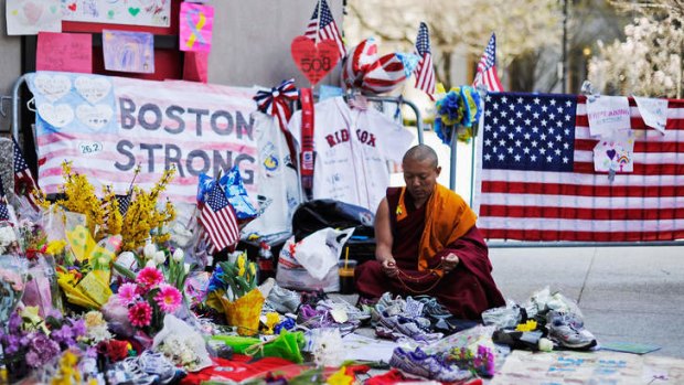 Silent vigil: A Buddhist monk meditates during a moment of silence near the finish line of the Boston Marathon bomings.