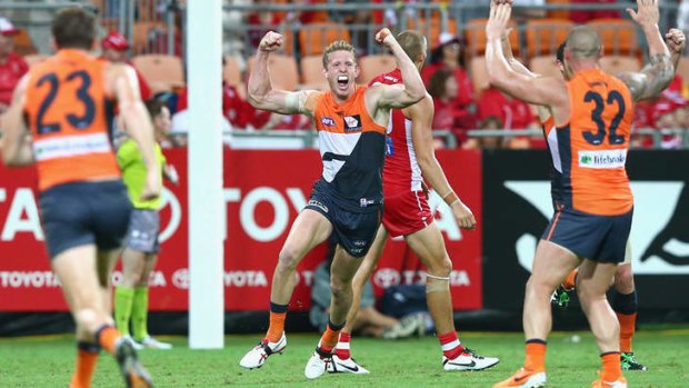 Sam Frost of the Giants celebrates kicking a goal.