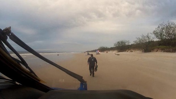 Emergency crews arrive at the scene of a paraglider crash on Bribie Island.